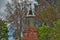 Very old mausoleum built into the side of a hill with steeple, tombstones, and wrought iron fence