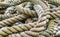 Very old pile of disordered textured seafaring ropes used for mo