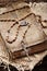Very old prayer book and vintage rosary on wooden background