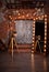 A very old rarity photo camera stands on a tripod near a huge mirror with lights in the Studio with brick background