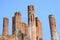 Very old red brick pole, old temple, on blue sky background