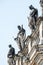 Very old roof statutes of high ranked priests lined up in historical downtown of Dresden, Germany, details, closeup