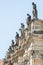 Very old roof statutes of high ranked priests lined up in historical downtown of Dresden, Germany, details, closeup