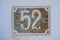 Very old rusty house number 52 plate
