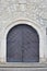 Very old solid door in brick stone wall of castle or fortress of 18th century