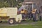 Very old straw press and yellow tractor