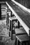 Very Old Weathered Wooden Chair Stools and Bench, Selective Focus on the most damaged one, Black and White classic style