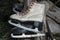 Very Old White and Black Rusty and Dirty Ice Skates Hanging in Warehouse