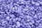 Very Peri. Color of the year 2022. Violet, purple colors. Close-up of crushed gravel as background or texture. Small