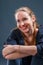 Very positive smiling blonde woman sitting on the floor