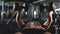 Very power athletic guy bodybuilder , execute exercise with dumbbells, in dark gym