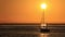 A very romantic sight, as a sailboat goes out to sea at sunrise.