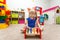 Very serious little girl playing with wooden hammer in kindergarten