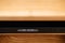 Very shallow focus of a high-end CD player in a wooden cabinet.