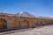 A very simple hostel in the middle of the Andes range mountains in Bolivia. Volcano in the background, blue sky day