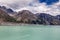 Very small boat in a beautiful turqouise Tasman Glacier Lake and Rocky Mountains, South Island, Ne