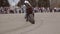 Very spectacular stunt on a motorcycle. The rider rides while standing with your foot on the stand and takes the race on a motorcy