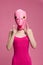 Very strange woman in a pink silicone fish mask for Halloween, crazy image in pink clothes
