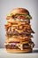 very tall layered burger symbolizing gluttony or a special offer of fast food