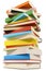 Very tall pile of books on white background, low angle view