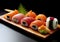 Very tasty sushi served in a professional way against a black background.