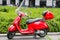 Vespa Italian red scooter in the street in Milano