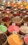 vessels filled with spices in various colors are offered from an oriental bazaar