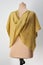 Vest knitted in ochre yarn. Layered spring clothing