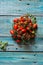 Vesuvius red Piennolo or simply Vesuvian Tomato, on blue wooden background. Piennolo is a cluster tomato grown in Naples, Italy