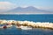 Vesuvius view from Naples bay, old boats on the sea.