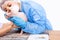 Vet doctor wearing ppe and protective medical mask looking at sphinx cat teeth. Veterinary stomatology, close up view