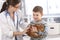 Vet helping little kid with rabbit