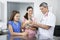 Vet Receiving Rabbit From Family In Clinic