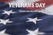 Veterans Day - Honoring All Who Served framed against an American flag