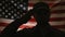 Veterans Day, Memorial Day. The silhouette of a sad soldier, with a u-turn saluting against the background of the American flag an