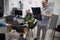 A veterinarian in an animal treatment clinic examines an x-ray of the bone system of a large dog. The owner of the dog is nearby