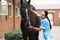 Veterinarian doctor listens with stethoscope to horse on farm