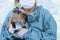 Veterinarian doctor or nurse wear blue uniform coat holding sick young rabbit in hand at hospital. Veterinary woman wear blue coat