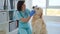 Veterinarian examining golden retriever dog teeth