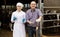 Veterinarian and farmer in cowshed