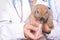 A veterinarian feeds a brown rabbit.