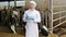 veterinarian with glass of milk on the farm