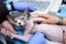 Veterinarian hand holding cat to carry an ultrasound examination, another hand adjusting ultrasonic machine