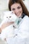 A veterinarian holding a white Persian Cat