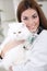 A veterinarian holding a white Persian Cat