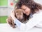 Veterinarian hugging and calms the dog