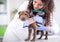 Veterinarian hugging Shar Pei dog