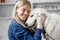 Veterinarian hugs the patient big white dog