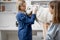 Veterinarian hugs the patient big white dog