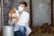 Veterinarian in mask holding brown chicken